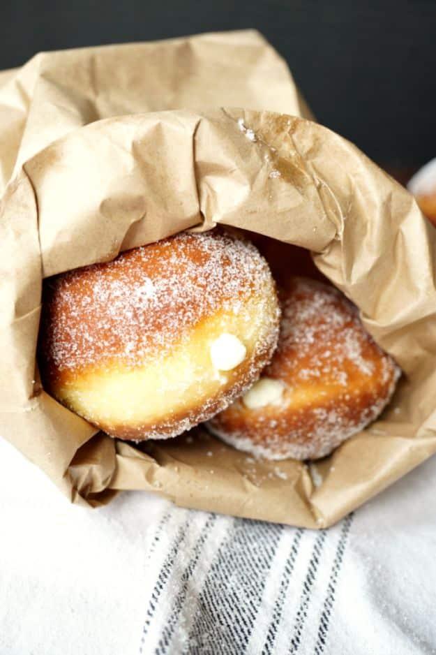 Bomboloni Italian doughnuts rolled in granulated sugar and stacked on a wire cooling rack after frying