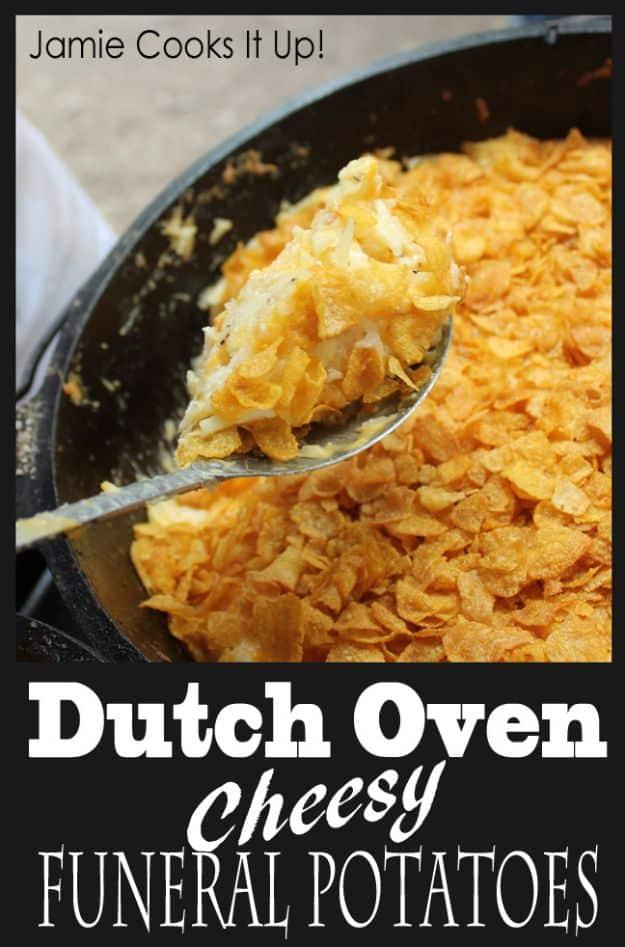 Cheesy funeral potatoes baked in a dutch oven with a buttery corn flake topping browned over the top