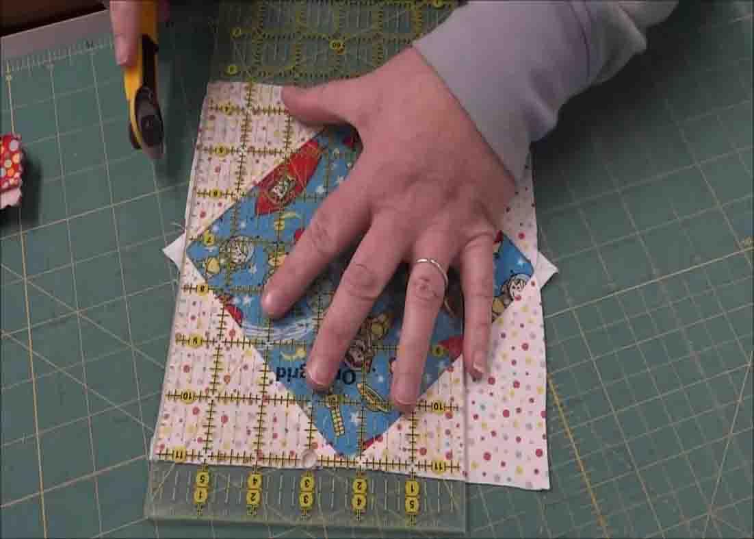 Cutting the dog ears from the i spy quilt