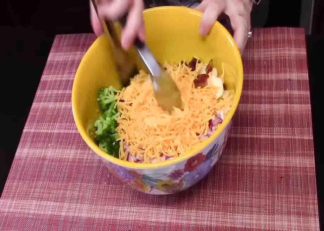 Tossing the salad to combine the ingredients well