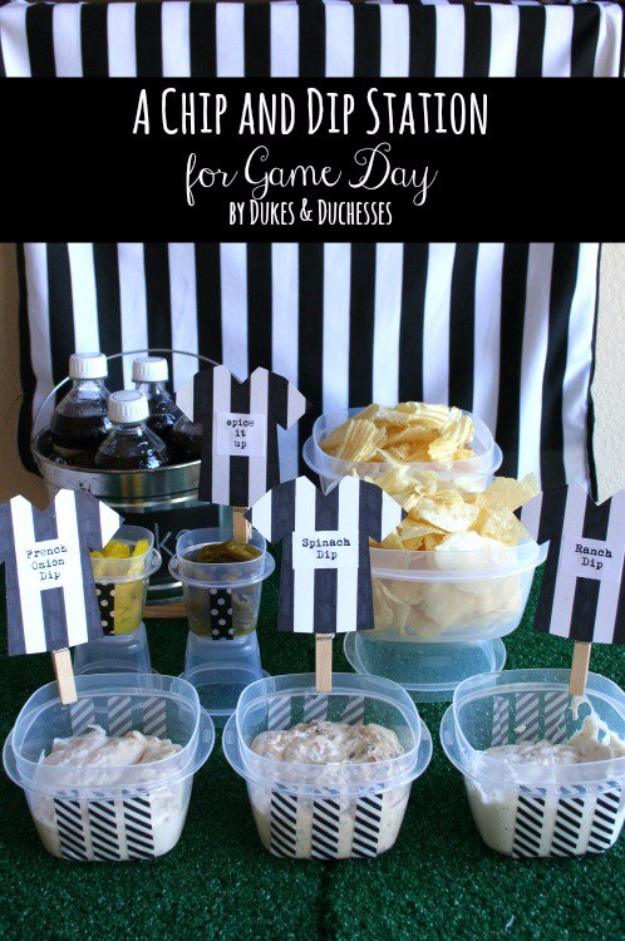 Game day chip and dip table with striped storage tubs, chips and referee shirt food labels on clothespins