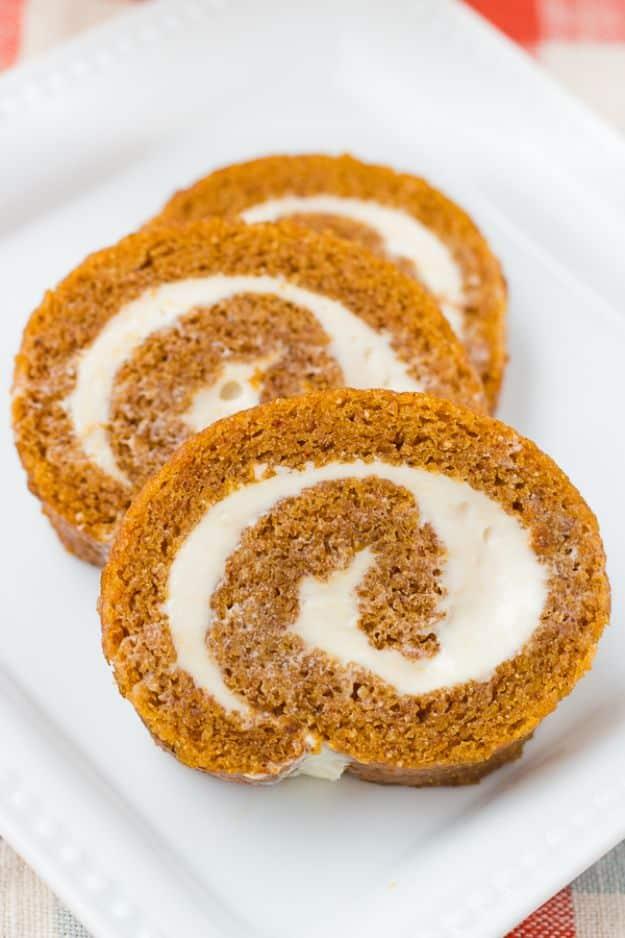 Gluten free pumpkin roll sliced to show the spiral of spiced pumpkin cake and cream cheese filling inside