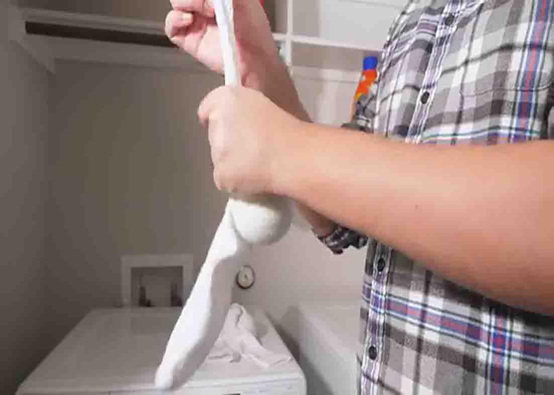 Throwing in a couple of tennis ball together with the comforter inside the dryer