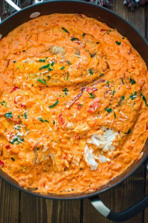 Tilapia fillets simmered in a creamy roasted red pepper sauce with parmesan and parsley, an easy skillet fish dinner