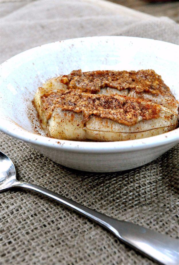 Baked almond butter banana boat with cinnamon, a warm healthy three ingredient snack served in the skin