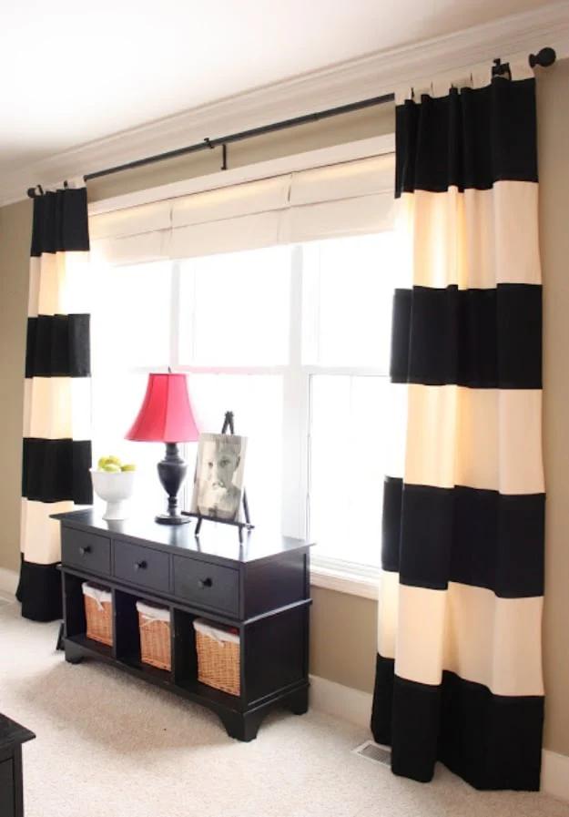 DIY drapery panels in cream cotton with wide black horizontal stripes, hanging either side of a bright window