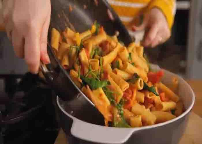 Transferring the pasta to the prepared casserole dish
