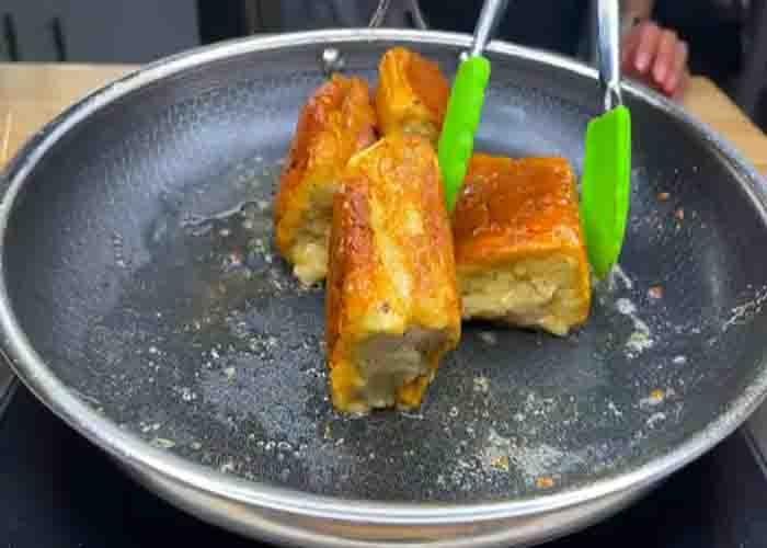 Toasting the Hawaiian roll French toast in the pan with melted butter