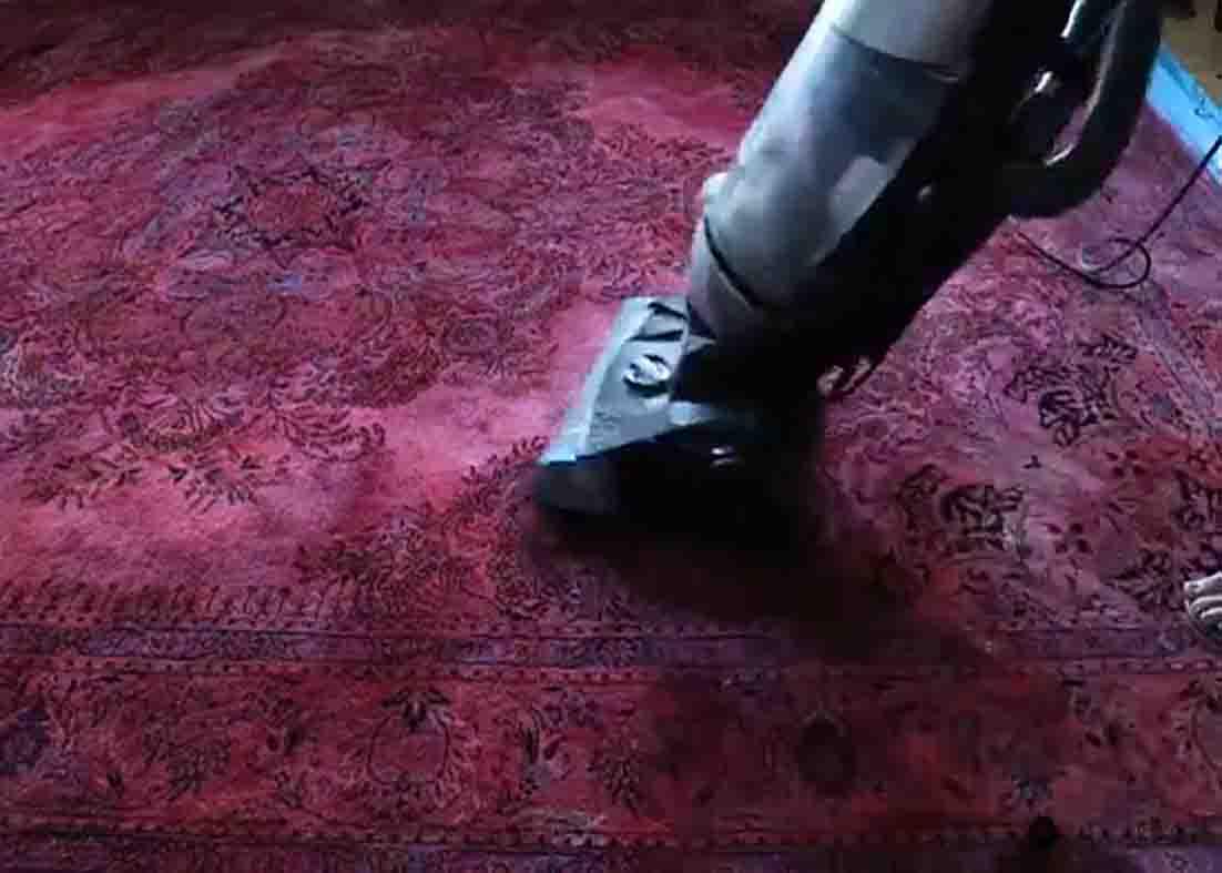 Vacuuming the painted rug to make it soft