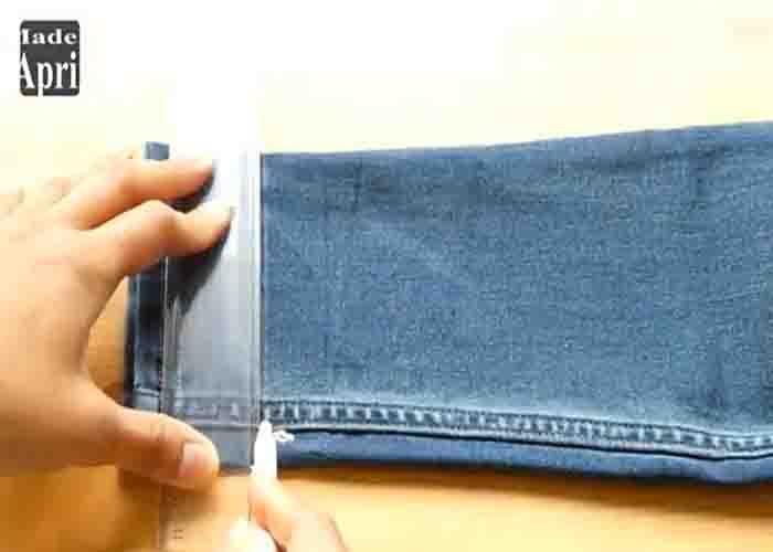 Drawing a line to the bottom of the jeans before adjusting the length