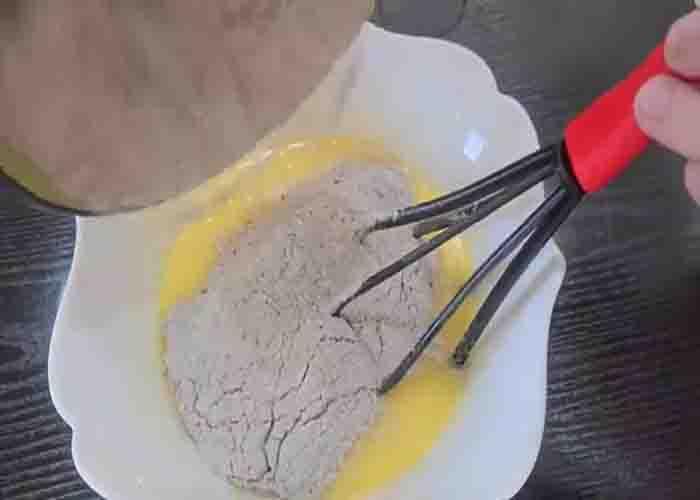 Combing the dry and wet ingredients to make the chocolate muffins batter