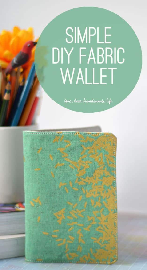 Simple DIY fabric wallet, a teal and gold printed canvas wallet standing upright beside a cup of colored pencils