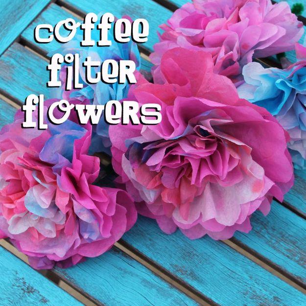 Coffee filter flowers, ruffled pink, magenta and blue dyed coffee filter flowers on a turquoise wood table