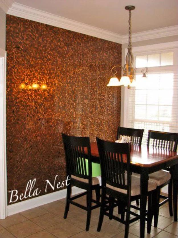 Penny accent wall behind a breakfast nook table and chairs, thousands of copper coins glowing under a chandelier