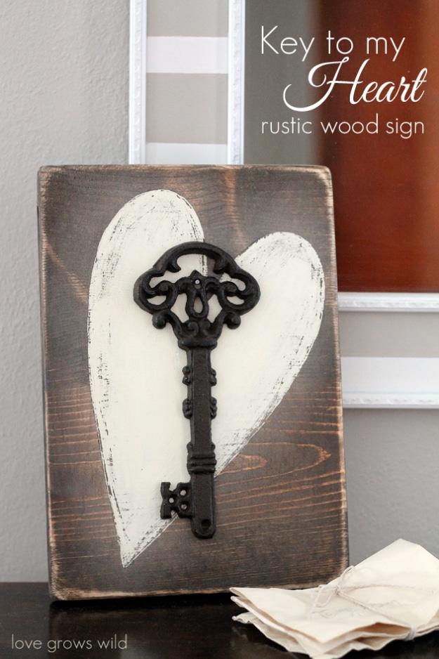 Rustic wood sign painted with Key To My Heart and vintage keys, an easy DIY Valentine decor idea for an entryway