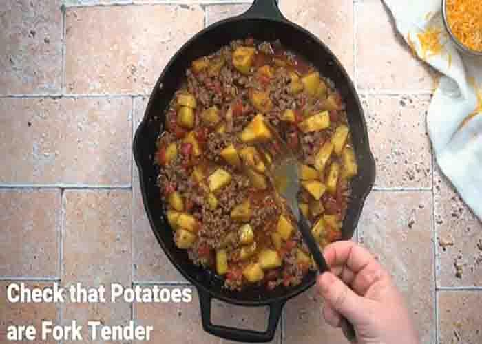 Cooking the taco potatoes with ground beef