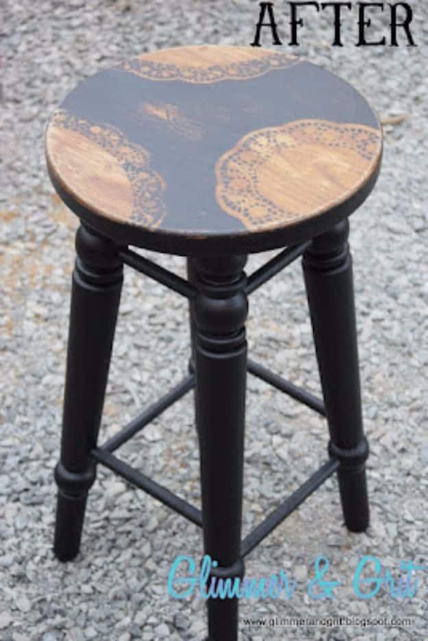 Dollar store doily stenciled stool with black turned legs and a black sprayed seat with lace shapes left in bare wood