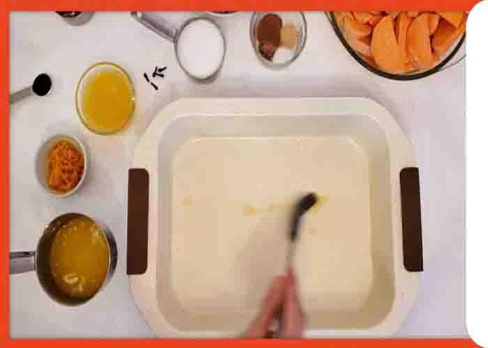 Greasing the casserole for the baked candied yams