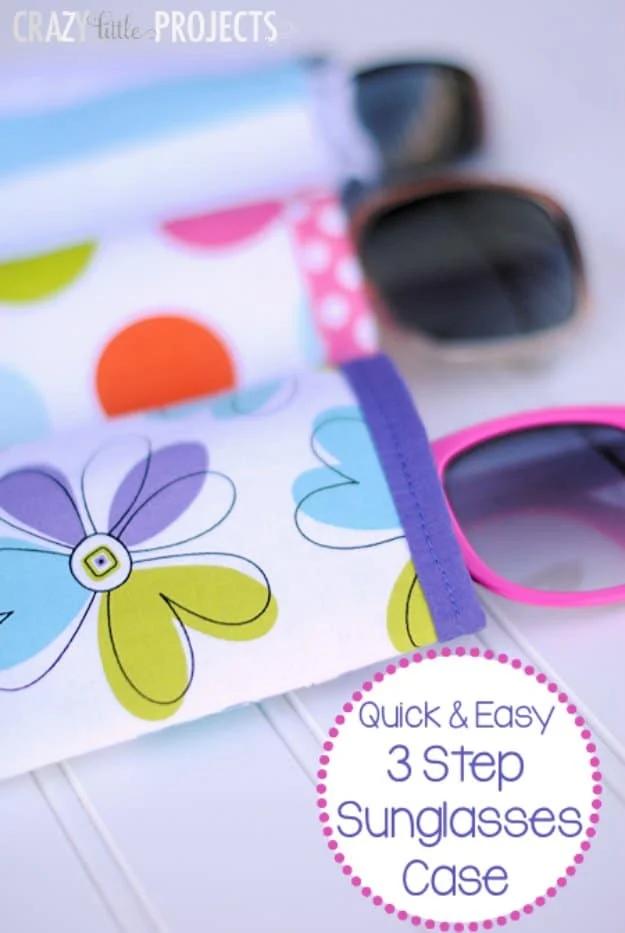 Floral fabric sunglasses case with a purple lining band at the opening, shown with two pairs of sunglasses