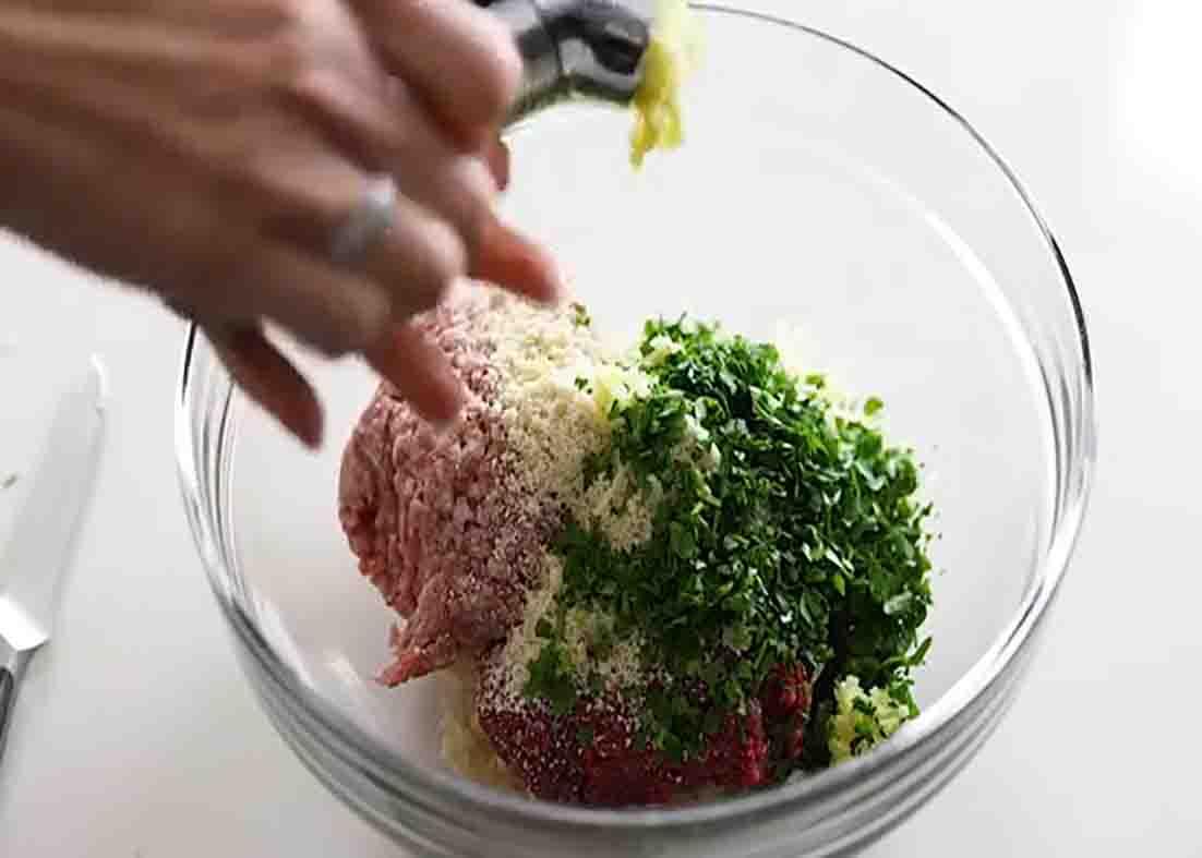 Mixing the ingredients to make the meatballs