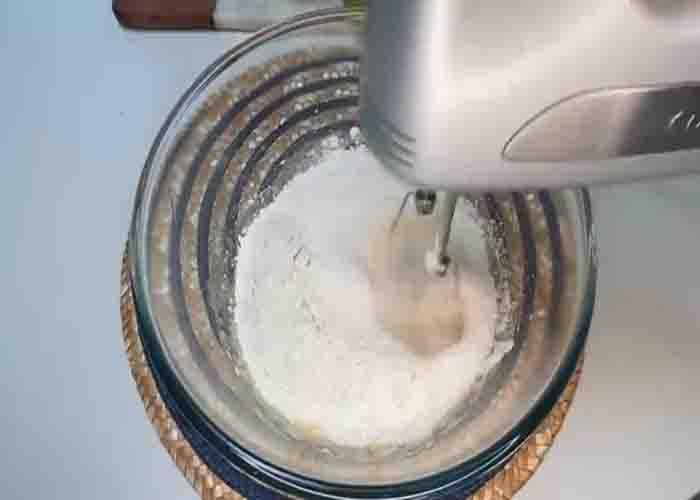 Mixing the flour to make the apple cookie batter