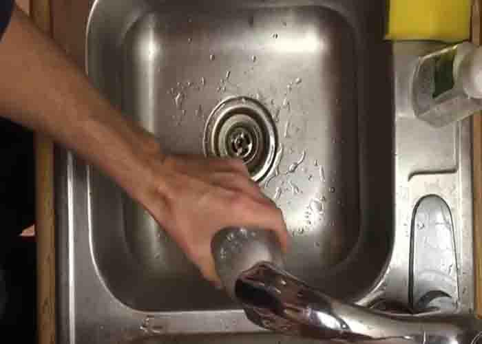 Filling the glass with water to peel the hard boiled egg