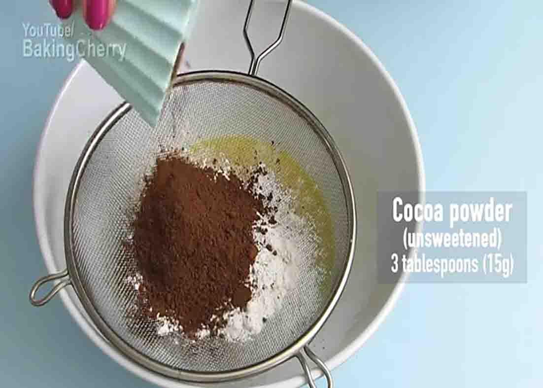 Straining the flour into the cheesecake batter