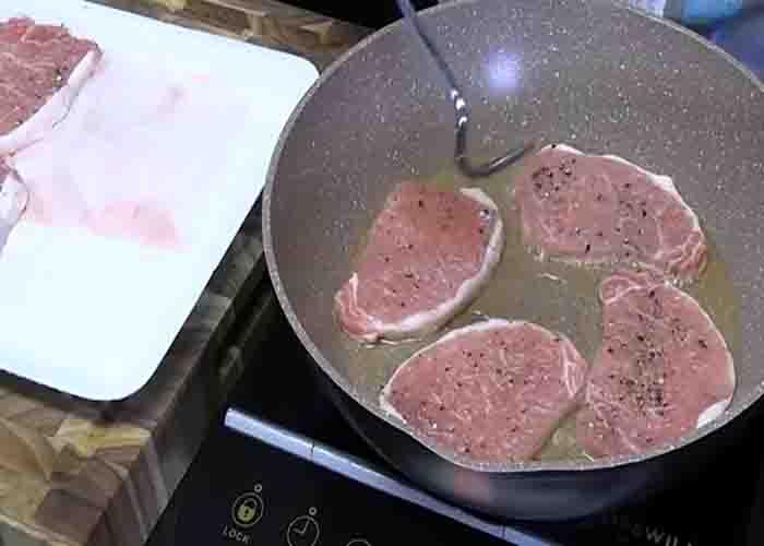 Searing the pork chops before slow cooking