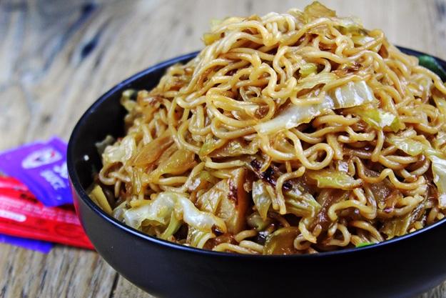 Panda Express chow mein copycat with yakisoba noodles, sliced cabbage, celery and caramelized onion in a pan