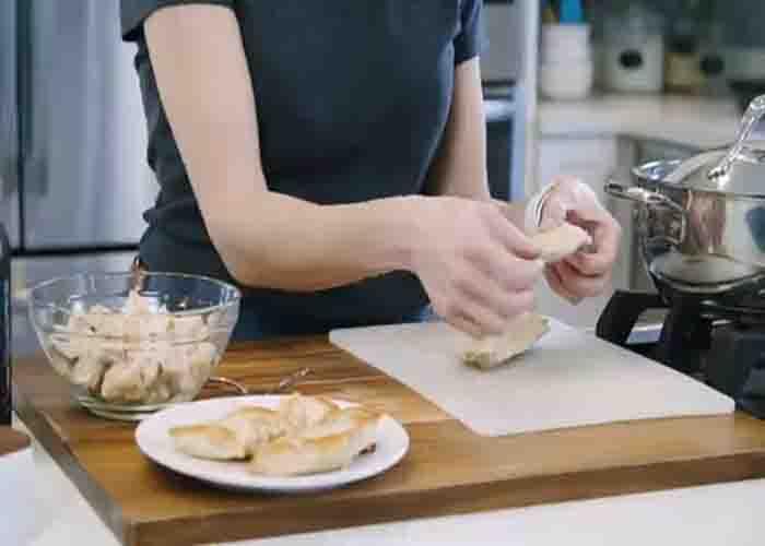 Shredding the chicken breasts using hands