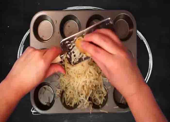 Shredding the potato for the hashbrown cups