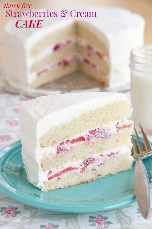 Gluten free strawberries and cream layer cake with whipped cream frosting and fresh sliced strawberries