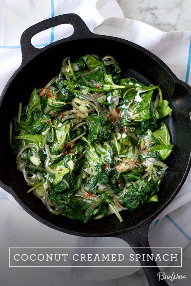 Coconut creamed spinach simmered dark green in a skillet with red onion, sliced garlic and smoked paprika