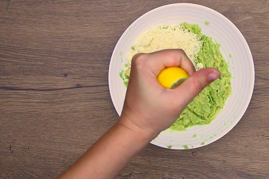 Squeezing fresh lemon juice into the avocado and parmesan mixture