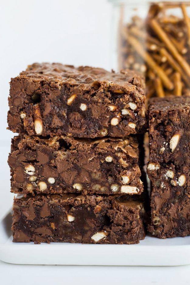 Pretzel toffee chip brownies stacked three high showing pretzel pieces and toffee bits through the chocolate