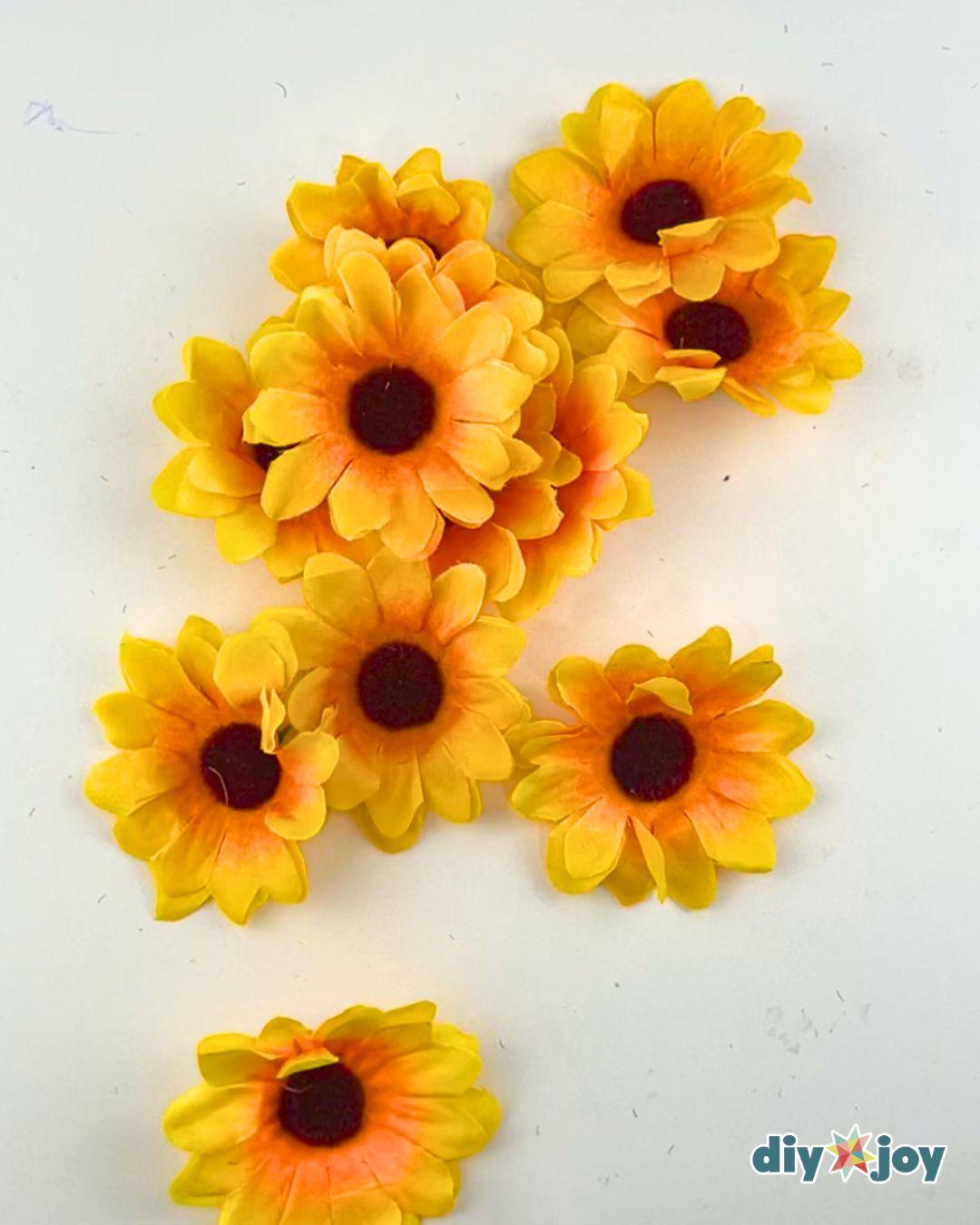 Easy Couples Costume Sunflower And Gardener - fake sunflowers pulled off their stems and sorted by size for gluing.