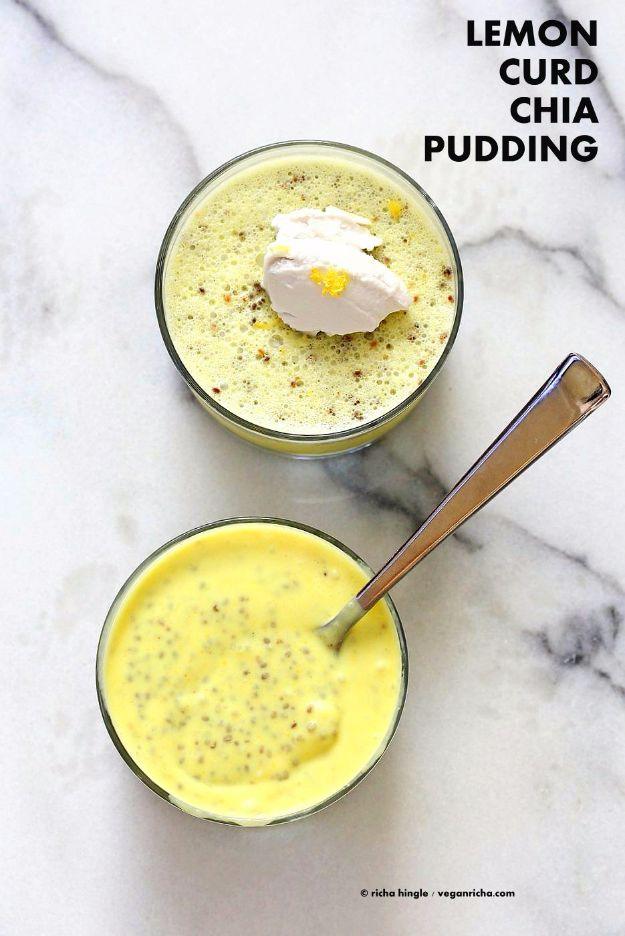 Two glasses of yellow lemon curd chia pudding on white marble, one topped with whipped coconut cream
