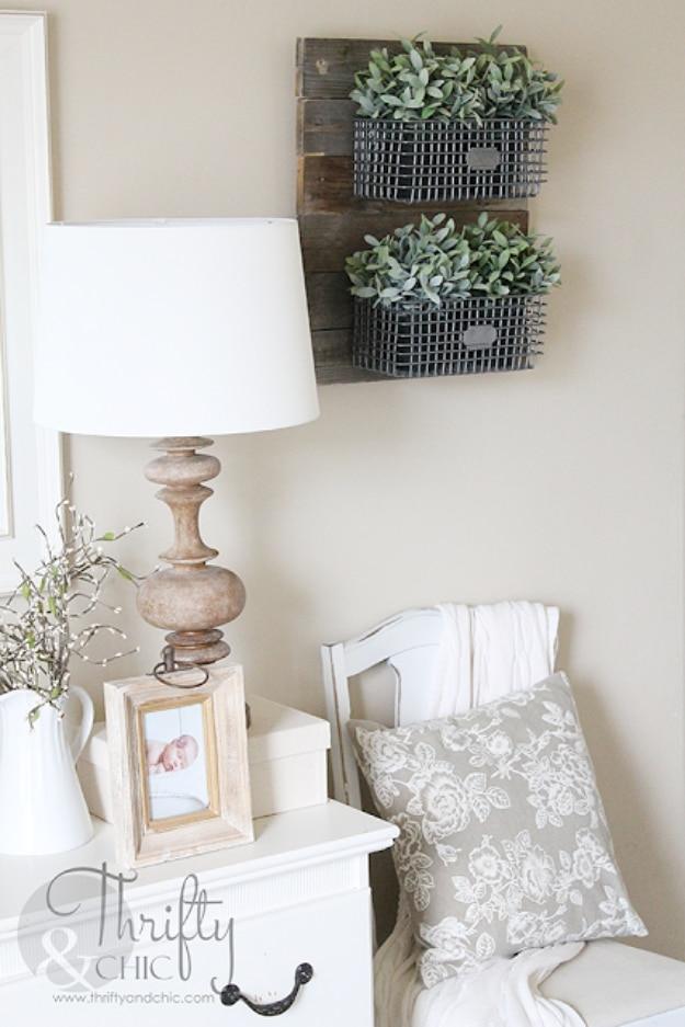 Farmhouse hanging wire baskets, three galvanized wall baskets of greenery on weathered boards above a white dresser