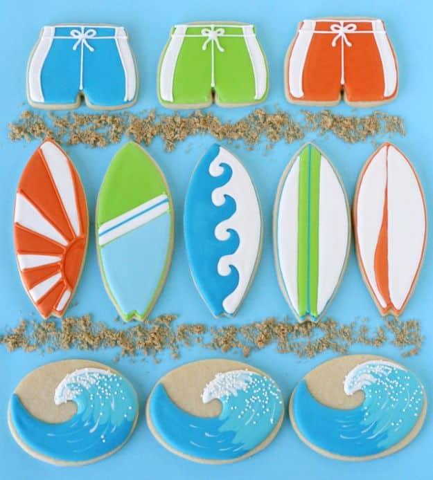 Surfboard and wave cookies iced in stripes and blues, a beach themed decorated cookie set for a party
