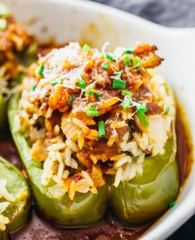 Easy Italian stuffed peppers halved lengthwise and filled with sausage and rice over a balsamic tomato sauce