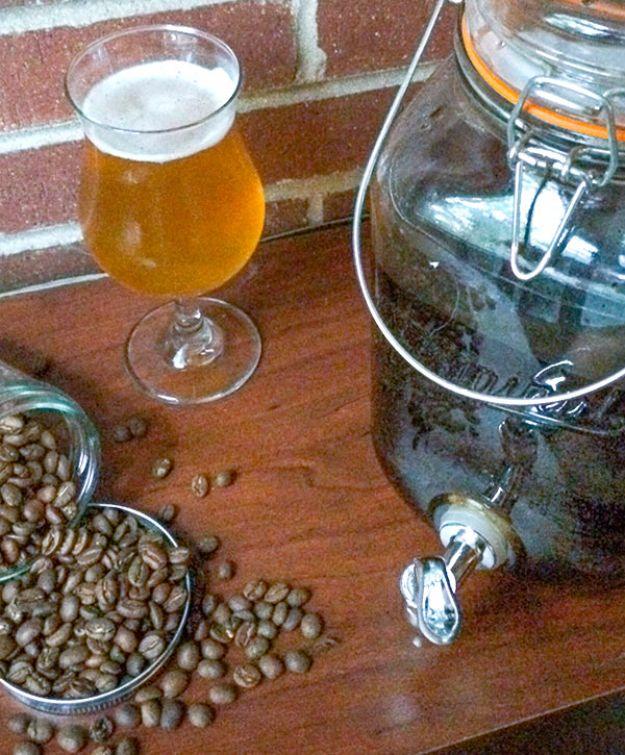 Cold brew coffee being strained through cheesecloth into a jar for adding to a homemade coffee beer homemade coffee beer