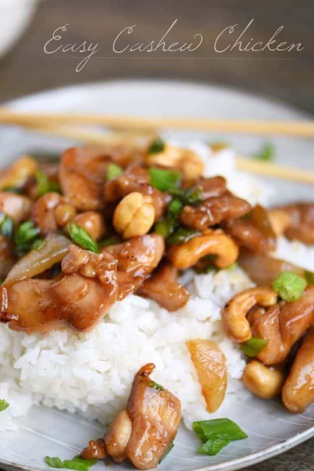 Easy cashew chicken with roasted cashews, sliced green onion and hoisin sauce served over hot white rice