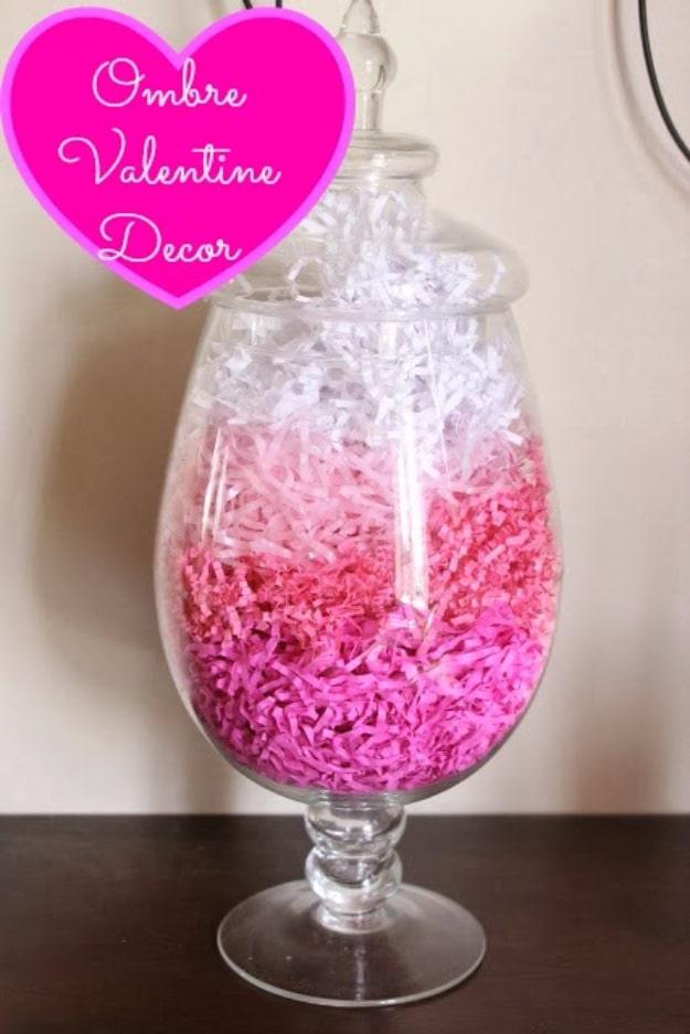 Ombre Valentine decoration with paper hearts graded from pale pink to deep red on a mantel display on a craft table