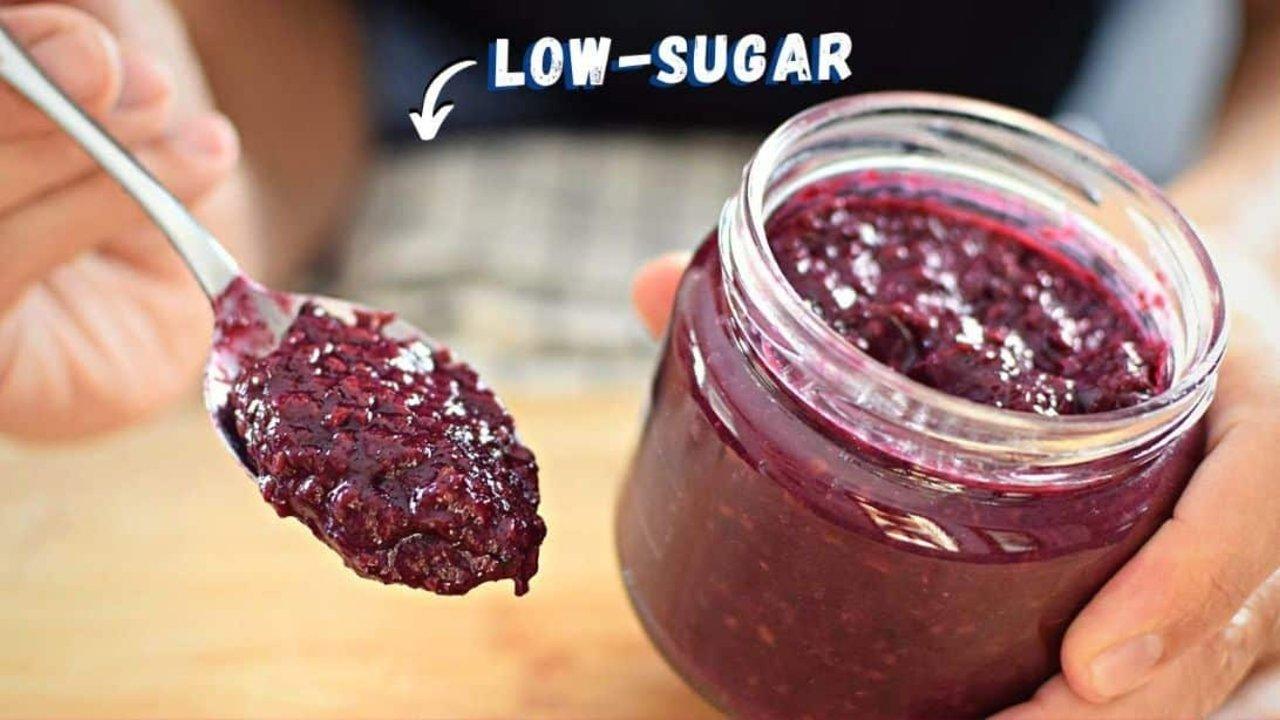 Healthy low sugar fruit jam made with mashed blackberries, apple and maple syrup, spread on toasted bread