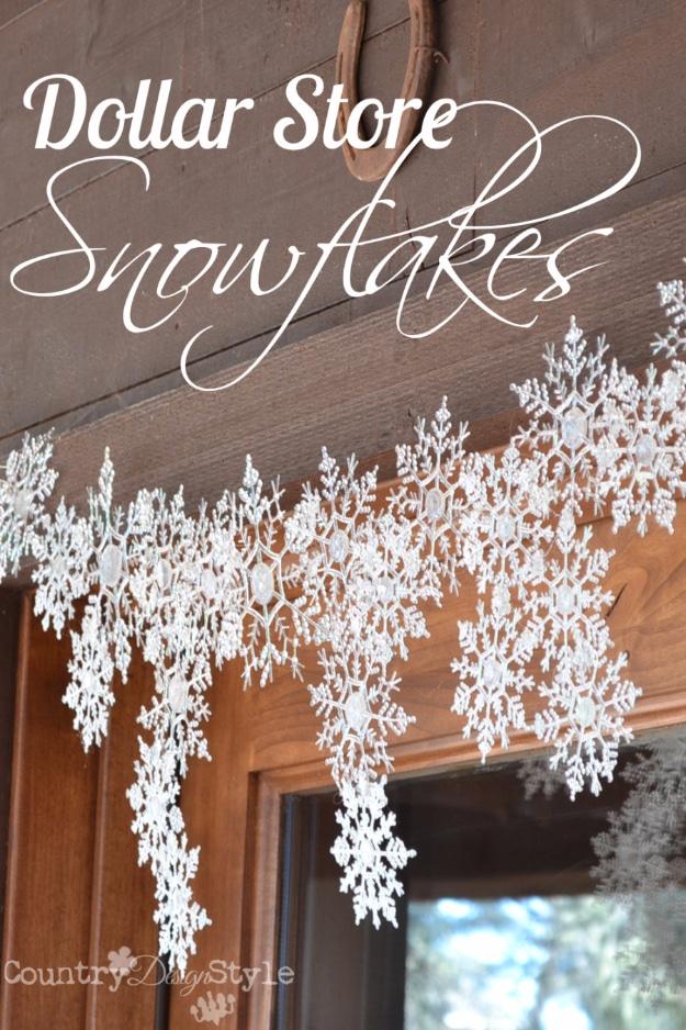 White glittered plastic snowflakes hot glued in a swag across the top of a wood and glass front door