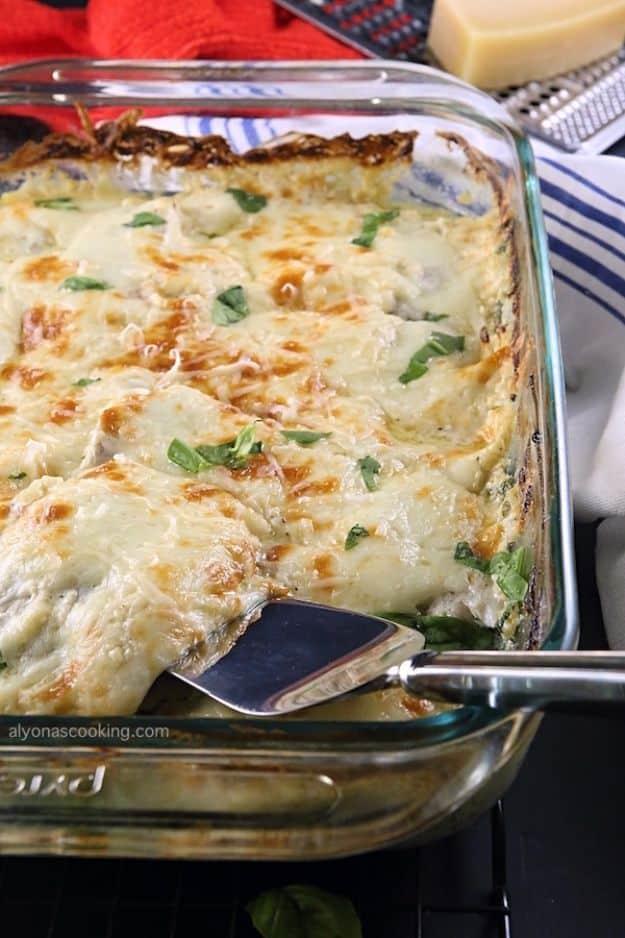 Creamy baked tilapia and spinach casserole with melted cheese in a baking dish, an easy seafood dinner recipe