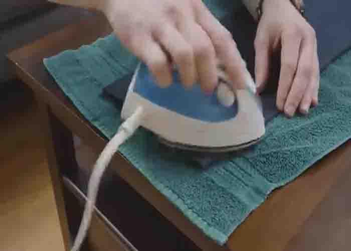 Pressing the new hem of the pants nicely with an iron