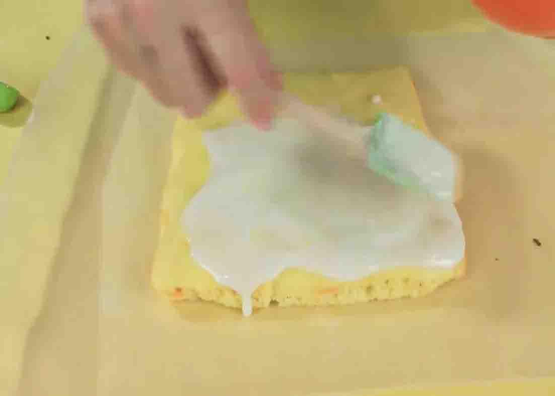 Spreading the glaze all over the top of the brownies