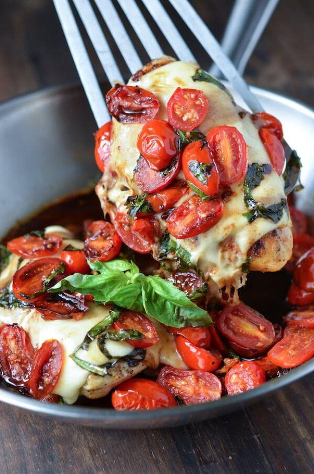 Caprese chicken for two in one pan topped with melted mozzarella, garlicky tomatoes and fresh basil leaves