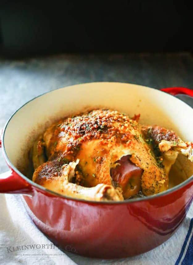 Whole garlic chicken roasted in a dutch oven, stuffed with an apple and brushed with a molasses Dijon glaze